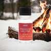 a 10ml clear bottle of Crackling log Fire fragrance oil in a christmas setting