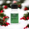 a 10ml clear bottle of Holly and Ivy fragrance oil in a christmas setting