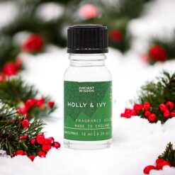 a 10ml clear bottle of Holly and Ivy fragrance oil in a christmas setting