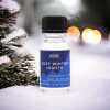 a 10ml clear bottle of Cosy Winter Nights fragrance oil in a christmas setting