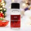a 10ml clear bottle of Frankincense fragrance oil in a christmas setting