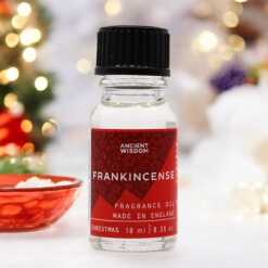a 10ml clear bottle of Frankincense fragrance oil in a christmas setting
