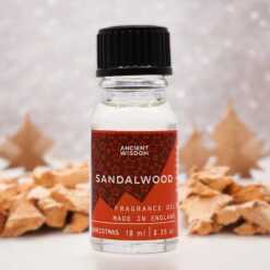 a 10ml clear bottle of Sandalwood fragrance oil in a christmas setting