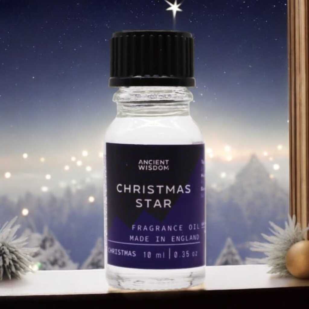 a 10ml clear bottle of Christmas Star fragrance oil in a christmas setting