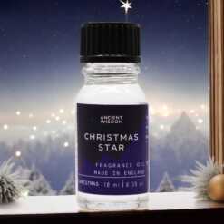 a 10ml clear bottle of Christmas Star fragrance oil in a christmas setting