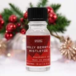 a 10ml clear bottle of Holly Berry and Mistletoe fragrance oil in a christmas setting