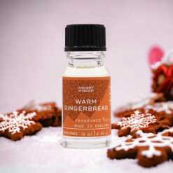 a 10ml clear bottle of Warm Gingerbread fragrance oil in a christmas setting