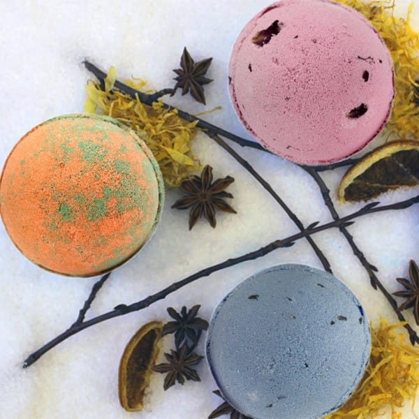 a selection of three jumbo bath bombs on a snowy background