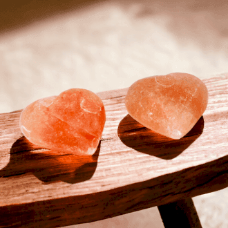 a pair of salt deodorants on a wooden table