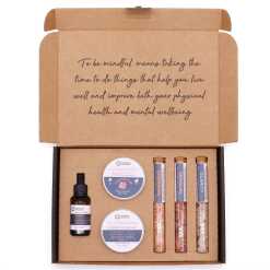 a serenity essential self care kit with scrubs, creams and bath salts in a presentation box