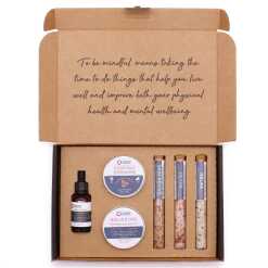 a mindful moments self care kit with scrubs, creams and bath salts in a presentation box