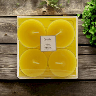 four yellow tealights in a transparent square package
