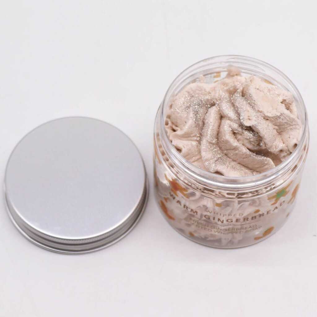 an open jar of Warm Gingerbread whipped soap, with lid