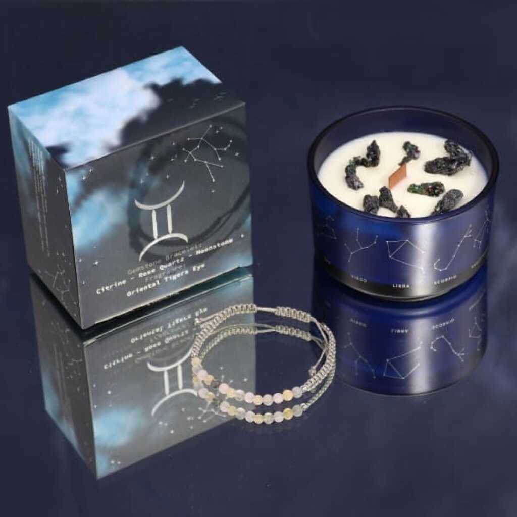 a zodiac candle with crystals and a gemstone bracelet - gemini