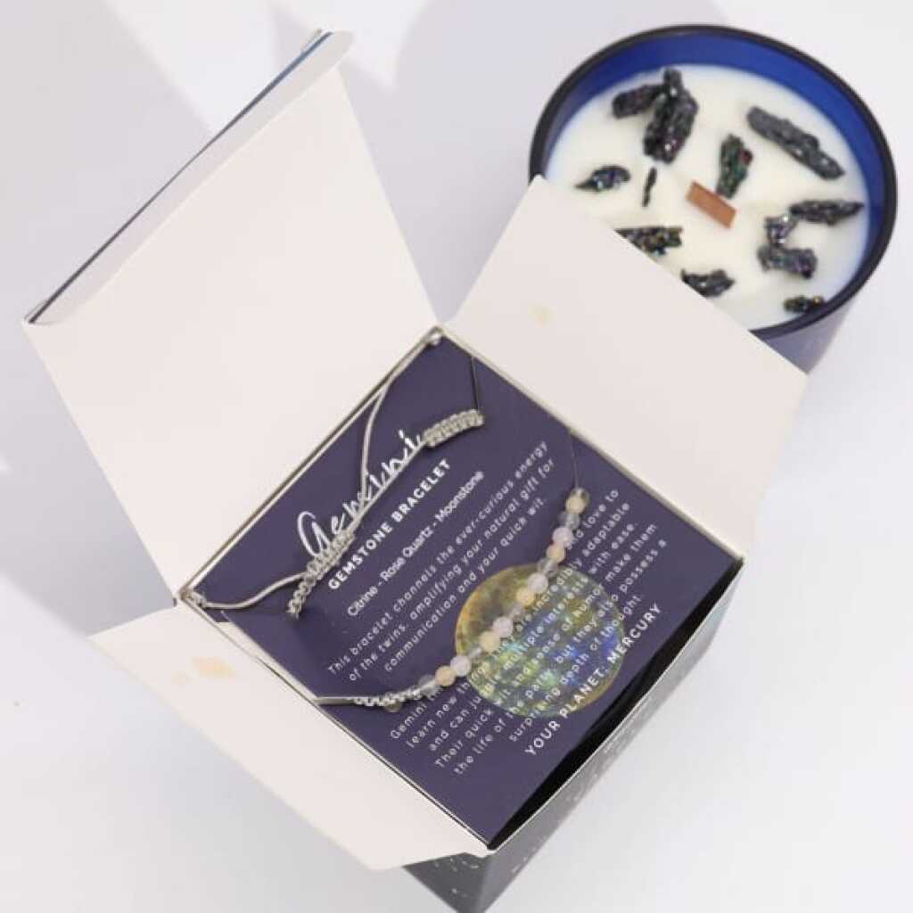 a zodiac candle with crystals and a gemstone bracelet - gemini