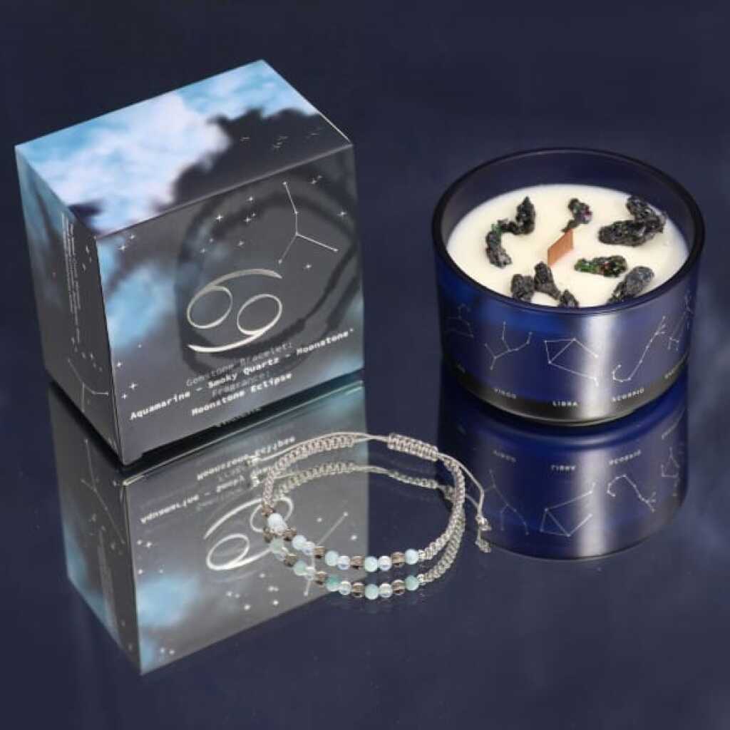 a zodiac candle with crystals and a gemstone bracelet - cancer