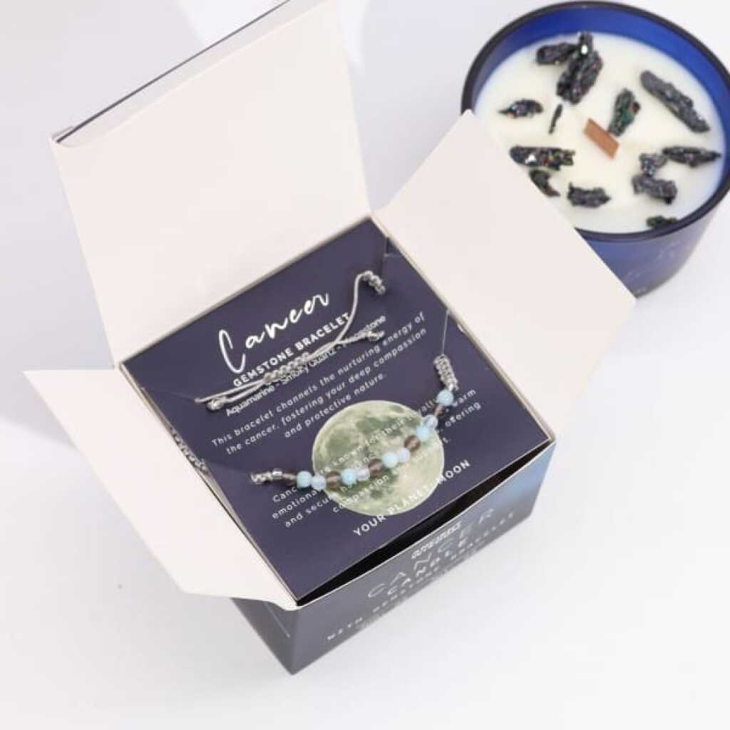 a zodiac candle with crystals and a gemstone bracelet - cancer