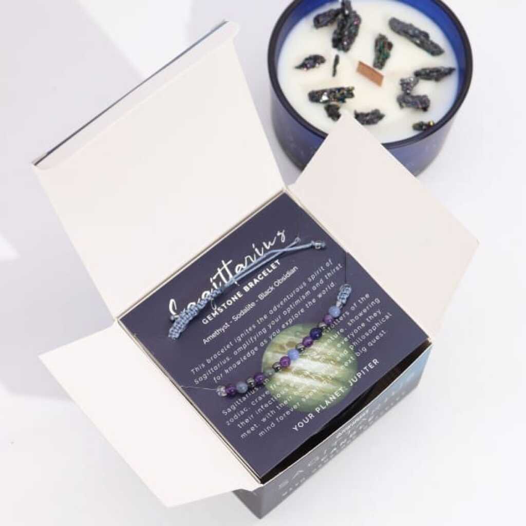 a zodiac candle with crystals and a gemstone bracelet - sagittarius
