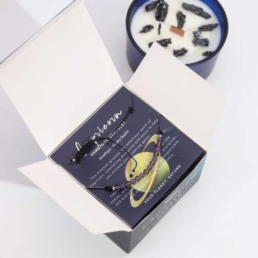 a zodiac candle with crystals and a gemstone bracelet - capricorn