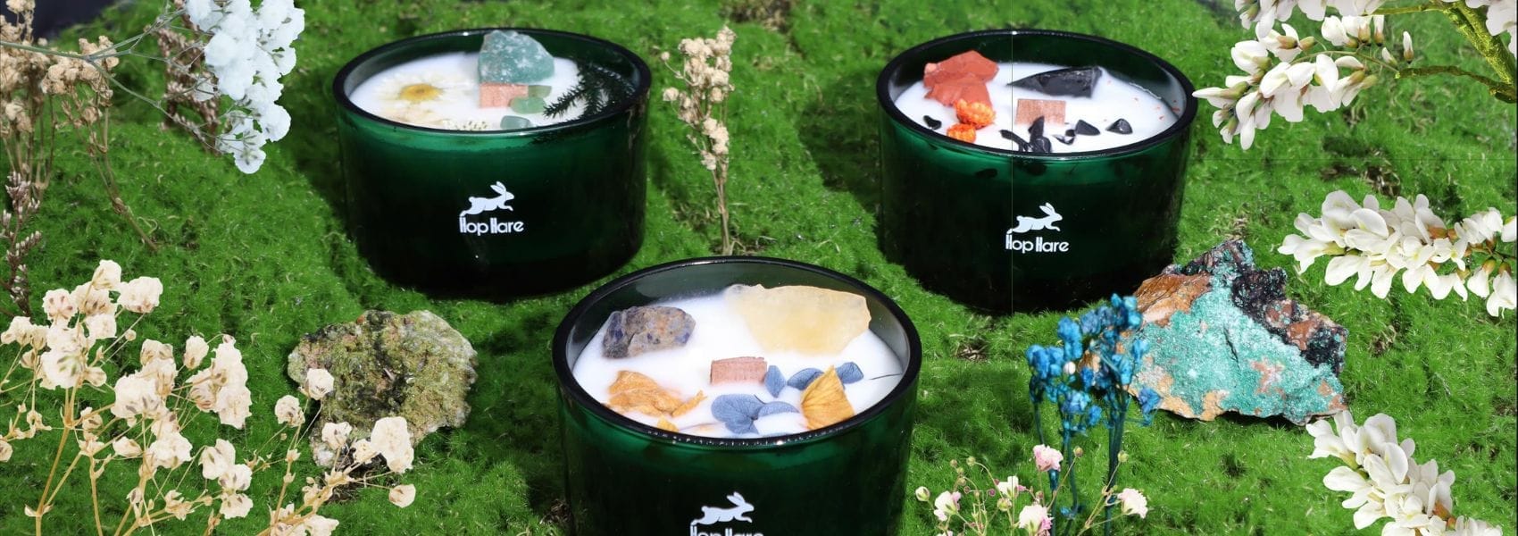 Hop Hare crystal candles on a green grass background