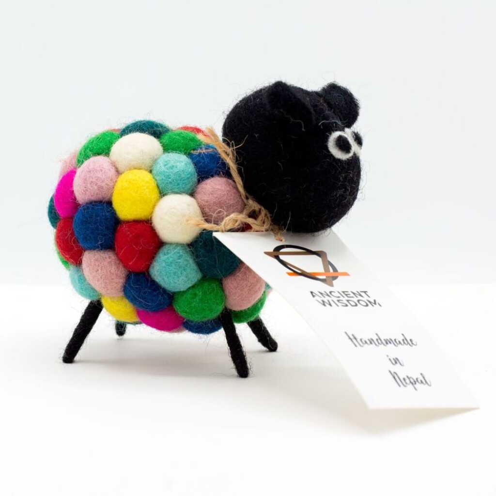 a little felt sheeps in multi-colours with a black head with a label around its neck