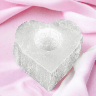 a selenite tea light holder on a pink cloth - an idea for Valentine's Day
