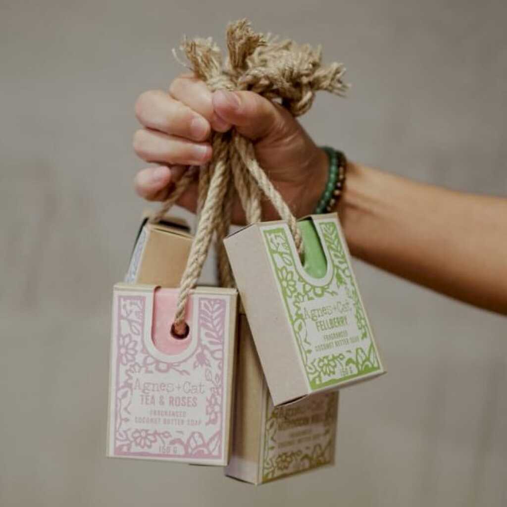 a collection of Agnes+Cat soap on a rope held aloft in a hand