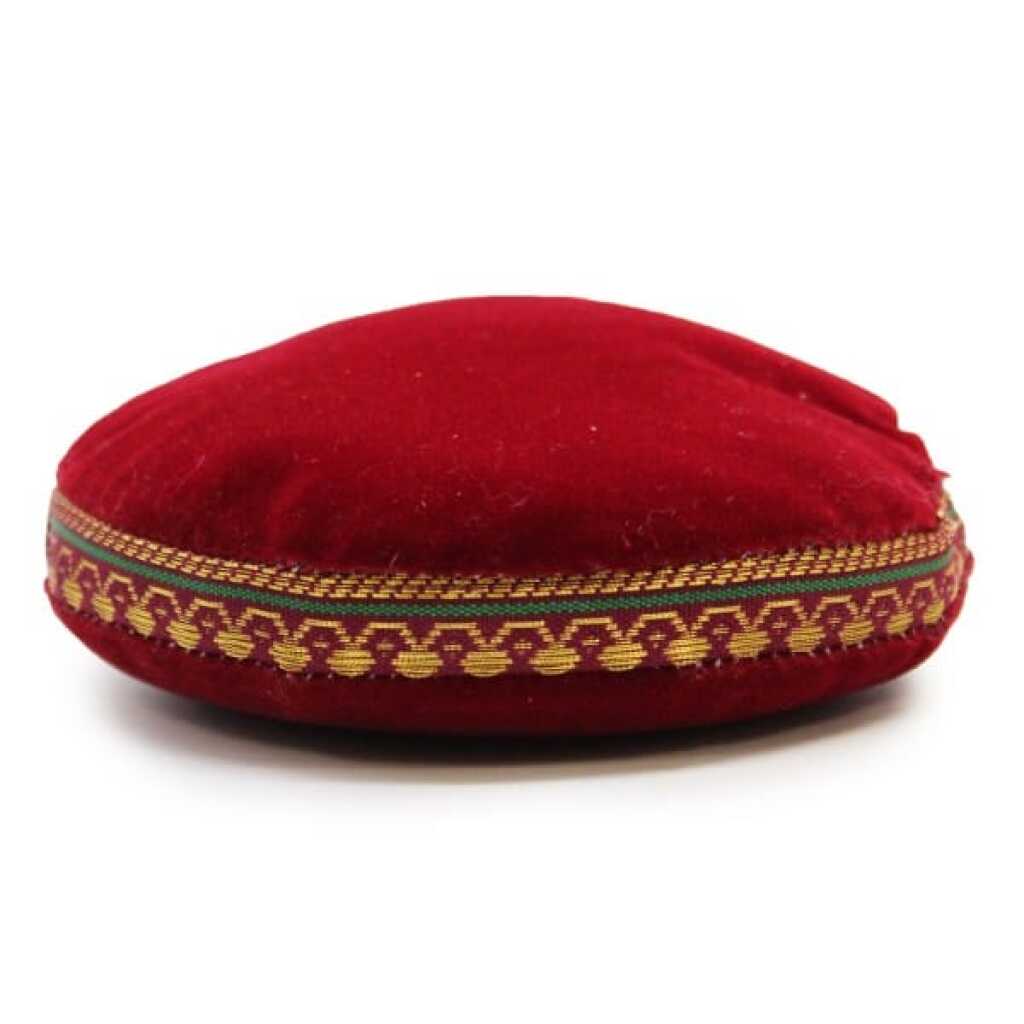 A 11cm, red velvet singing bowl cushion.
