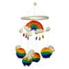 a colourful handmade felt mobile with four rainbow sheep and a rainbow.