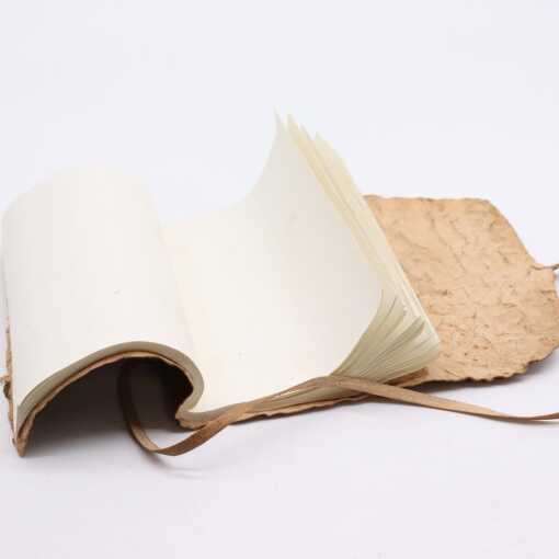 A rolled leather travel notebook, open at page