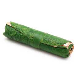 A rolled leather travel notebook in green, rolled up