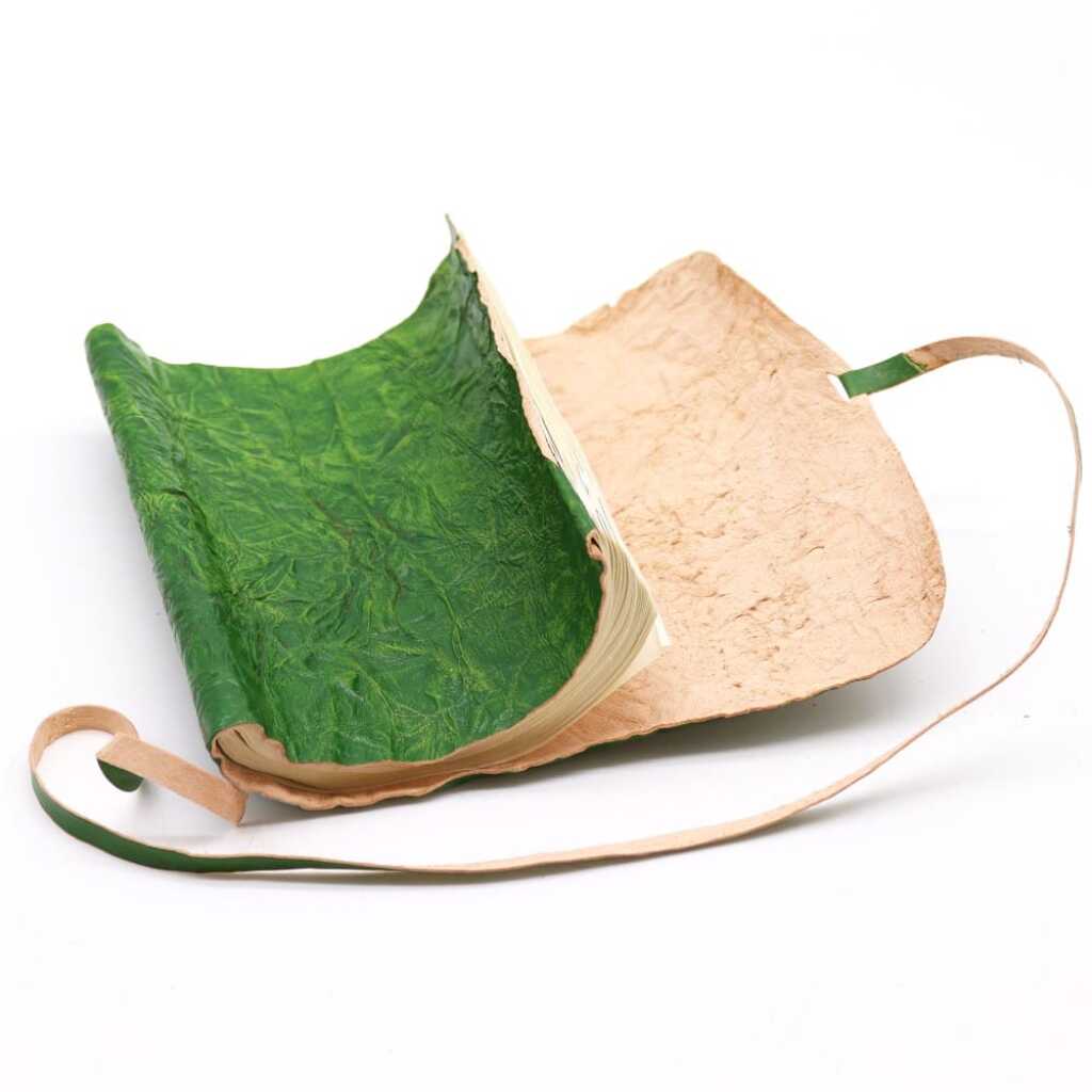 A rolled leather travel notebook in green, unrolled