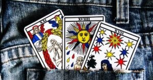 Three Tarot Cards in the back pocket of a pair of denims