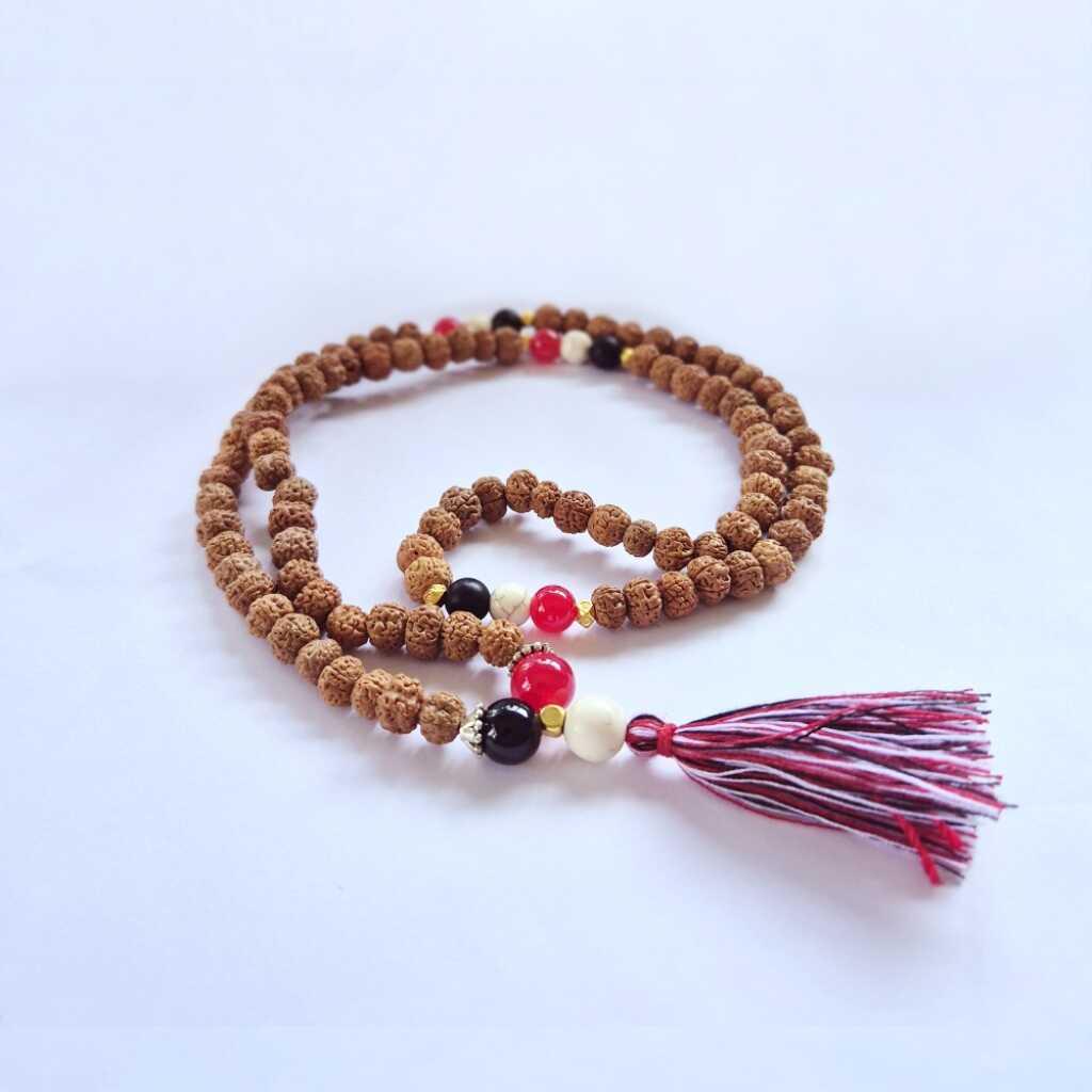 a Bali Mala Necklace with 108 Rudraksha beads and a tassel
