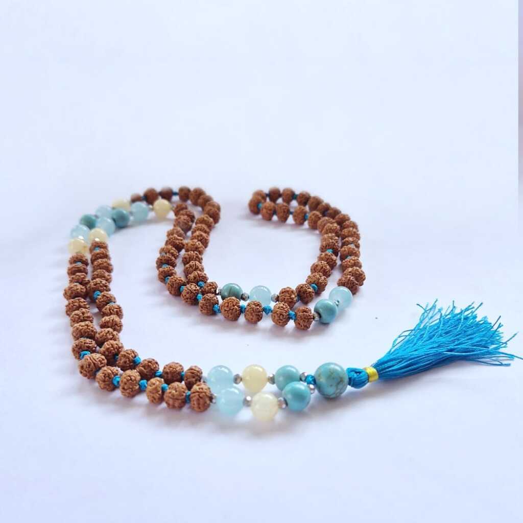 a Bali Mala Necklace with 108 Rudraksha beads and a tassel