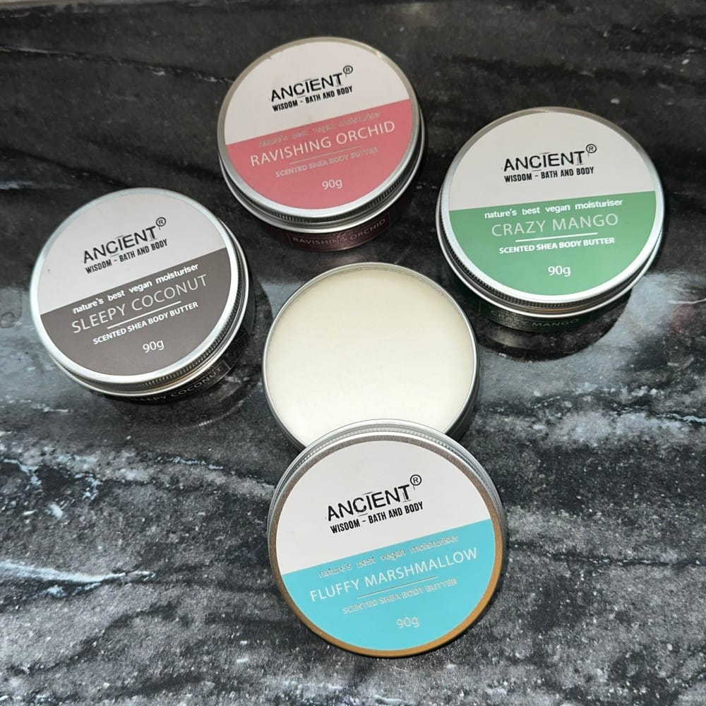 four different coloured tins of shea butter