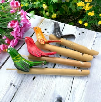 a selection of bird whistles on a table outside