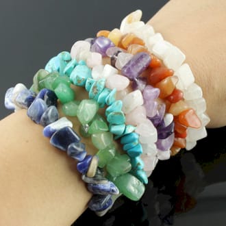 a selection of chipstone bracelets on a wrist.