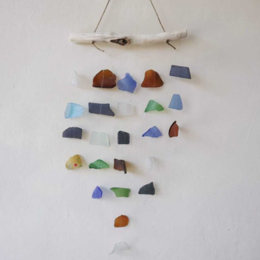 Driftwood and reclaimed glass wind chimes with five strings of beads.
