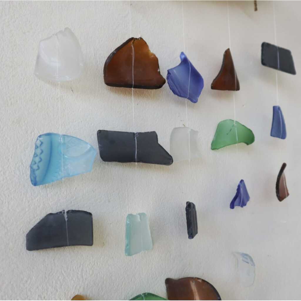 Driftwood and reclaimed glass wind chimes with five strings of beads.