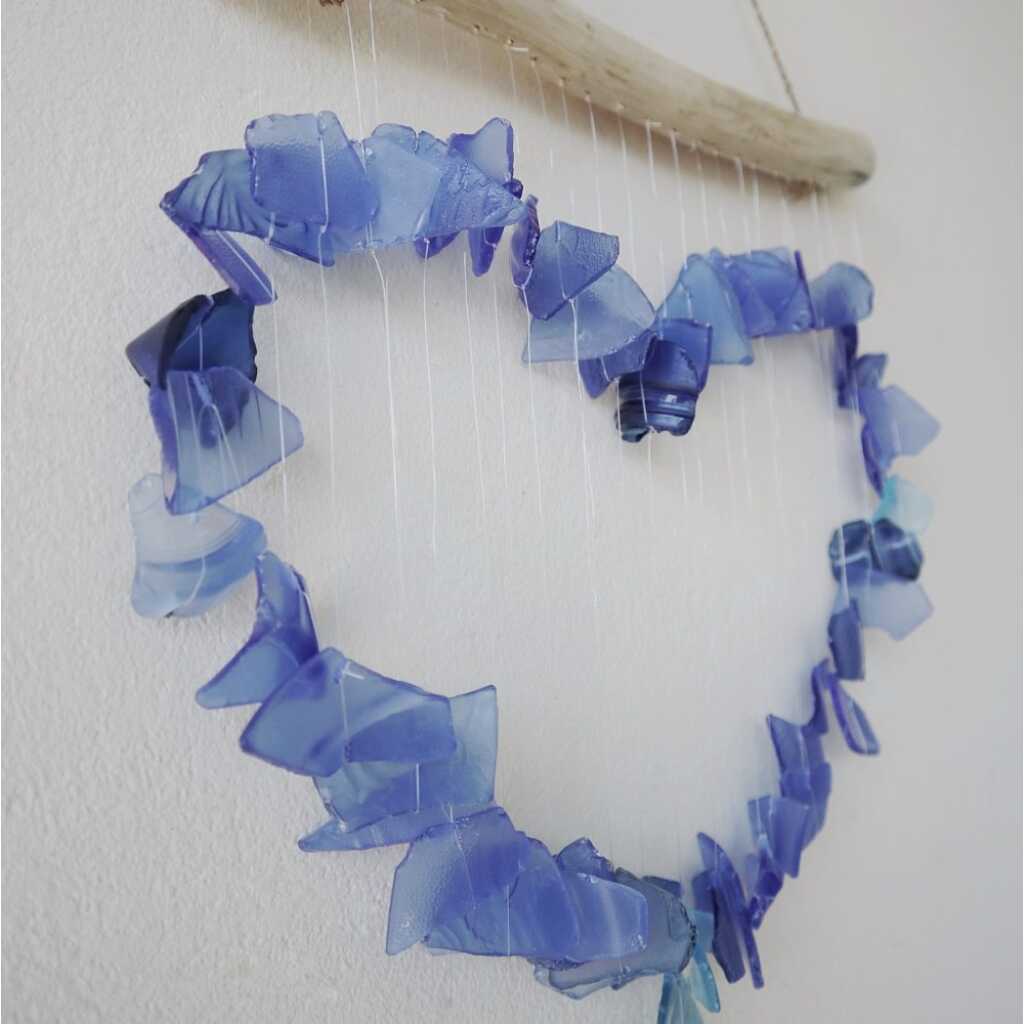 Driftwood and reclaimed glass wind chimes with one driftwood stick and a love heart made from blue glass