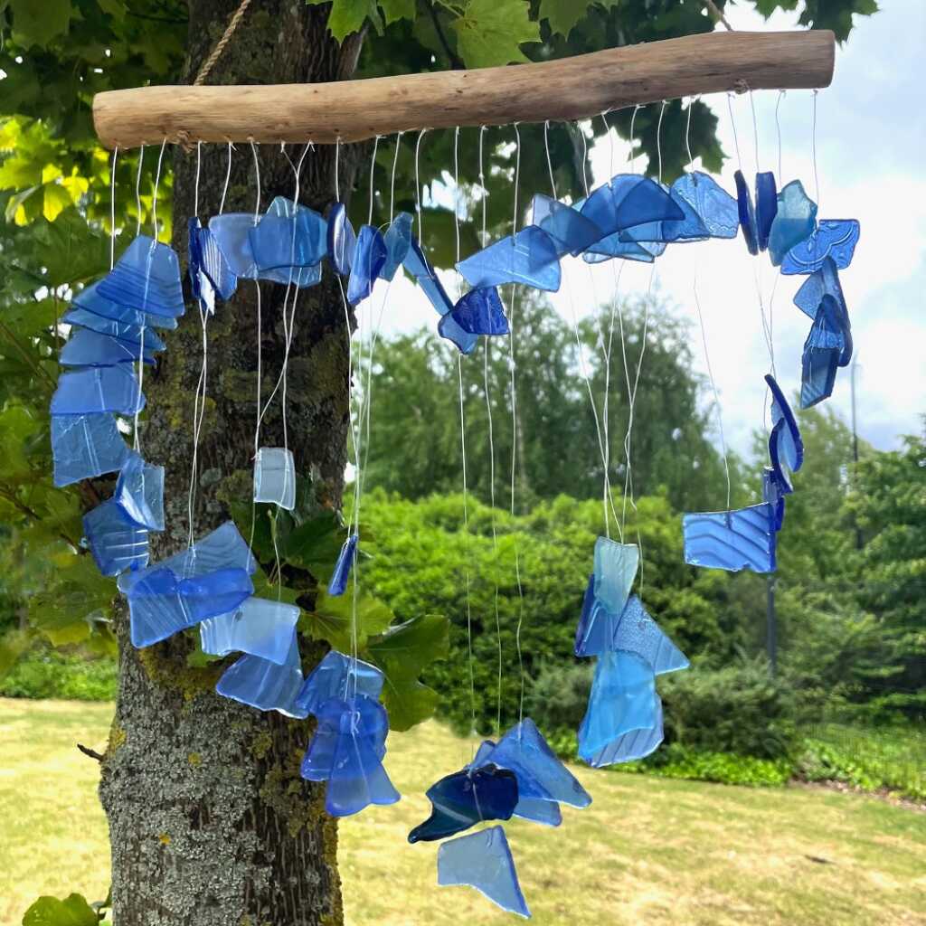 Driftwood and reclaimed glass wind chimes with one driftwood stick and a love heart made from blue glass