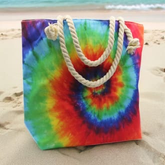 a psychedelic splash bag with spiral pattern on a beach