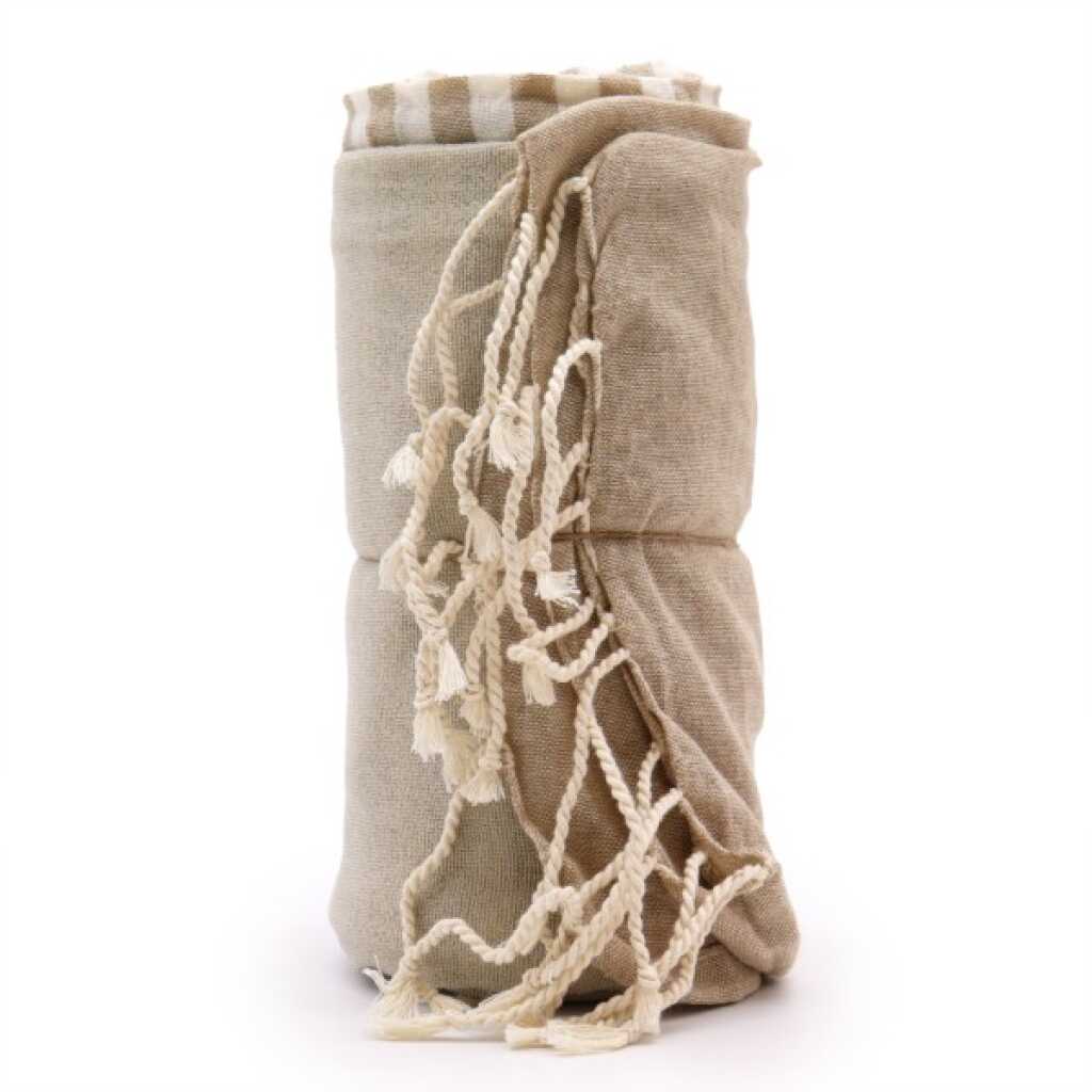 a rolled up, warm sand cotton pareo towel