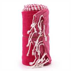 a rolled up, hot pink cotton pareo towel