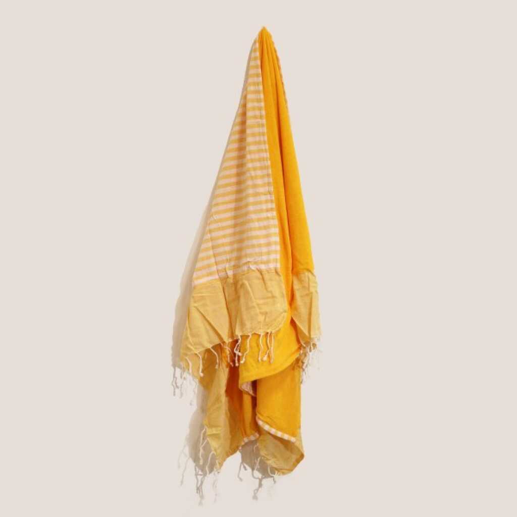 a sunny yellow cotton pareo towel, on a peg