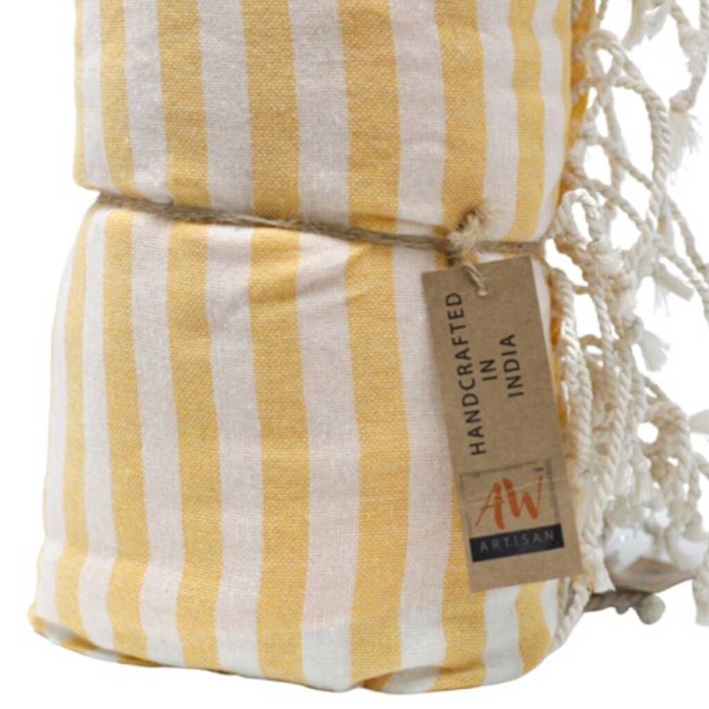 a rolled up, sunny yellow cotton pareo towel showing the label