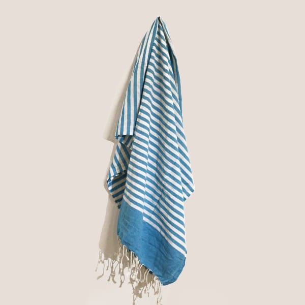 A blue and white striped cotton pareo throw