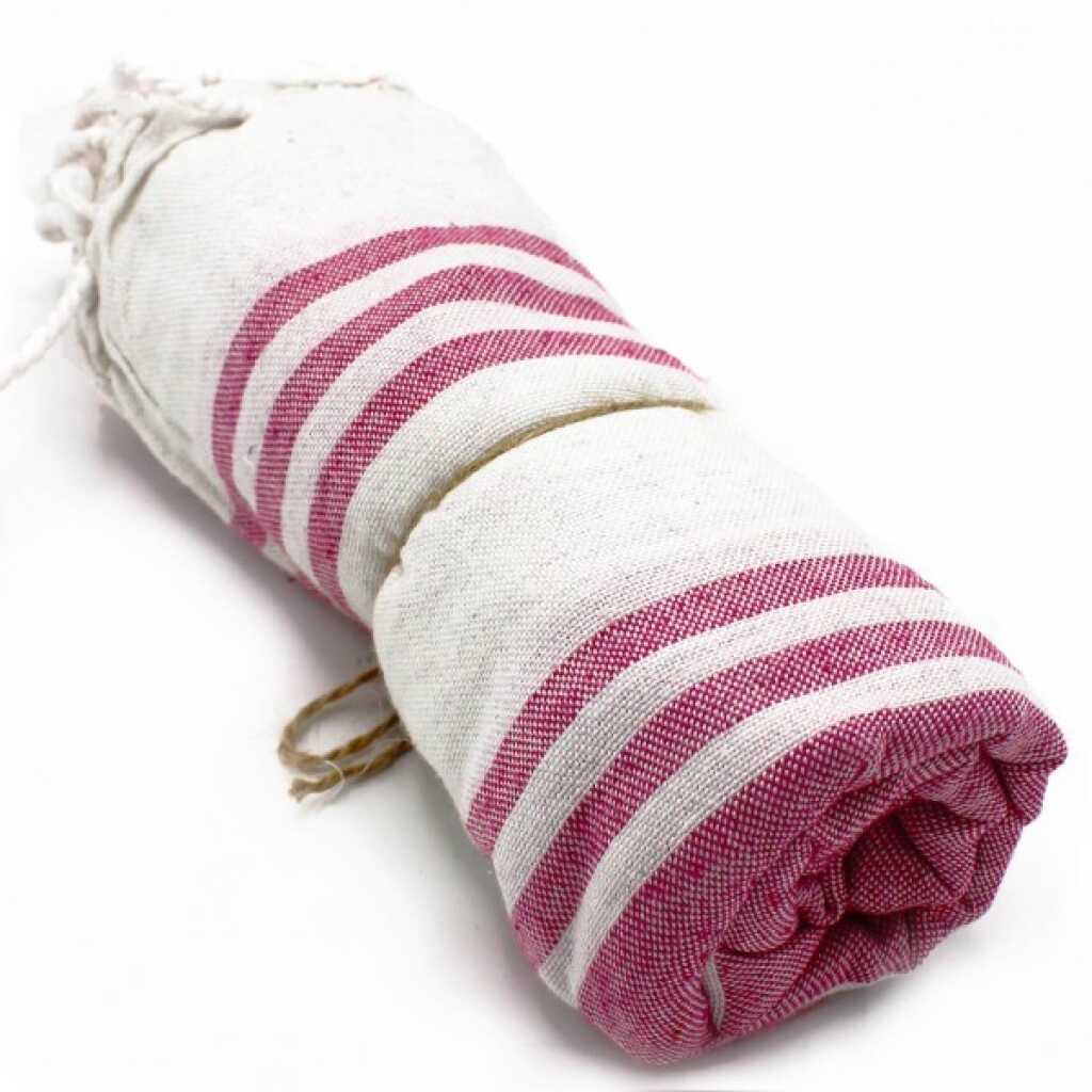 Hammam Spa towel in sunset pink colour, rolled up
