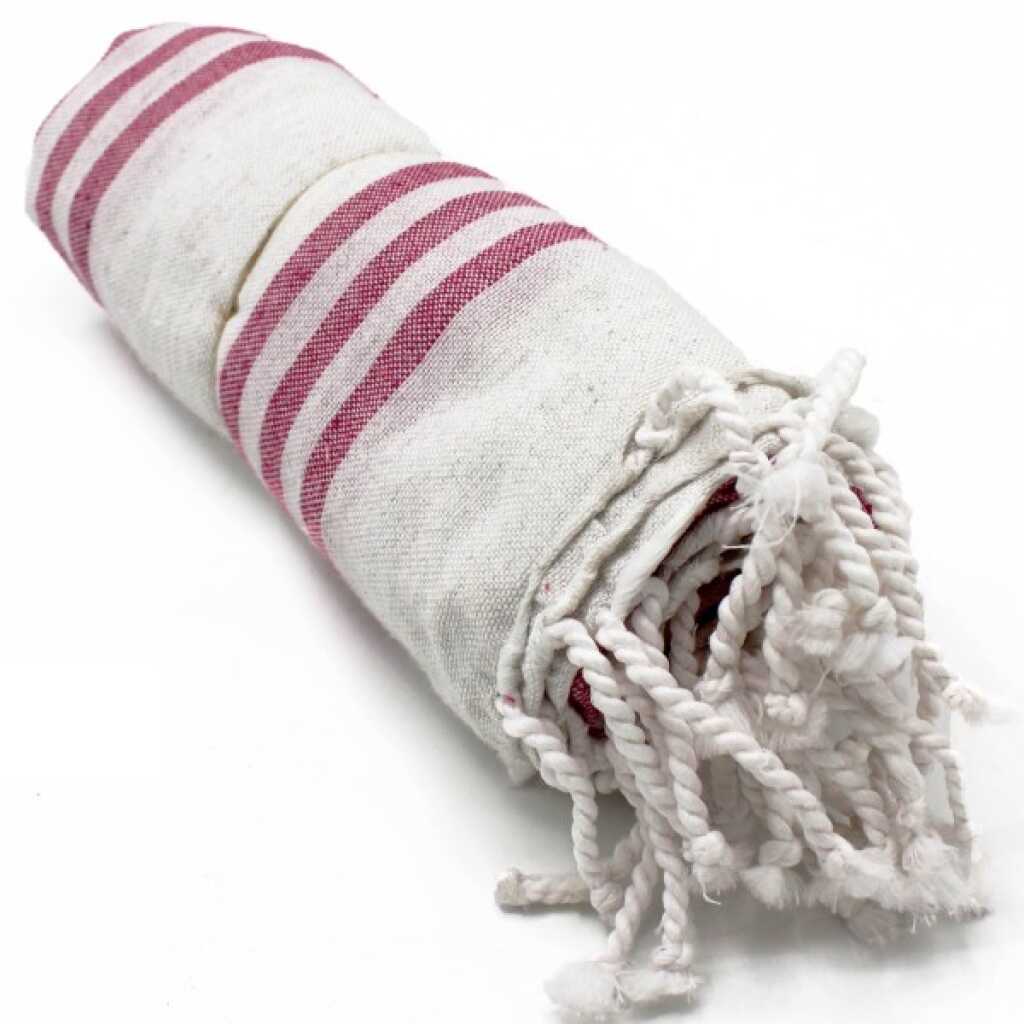 Hammam Spa towel in sunset pink colour, rolled up